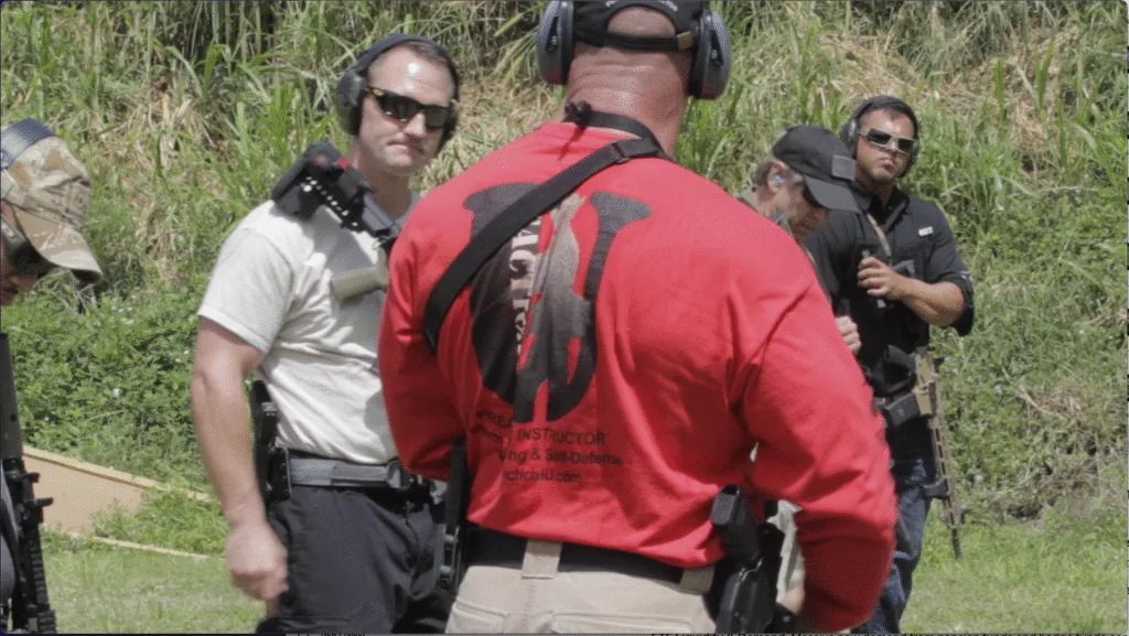 Tactical U instructor briefing a group of armed students on the range