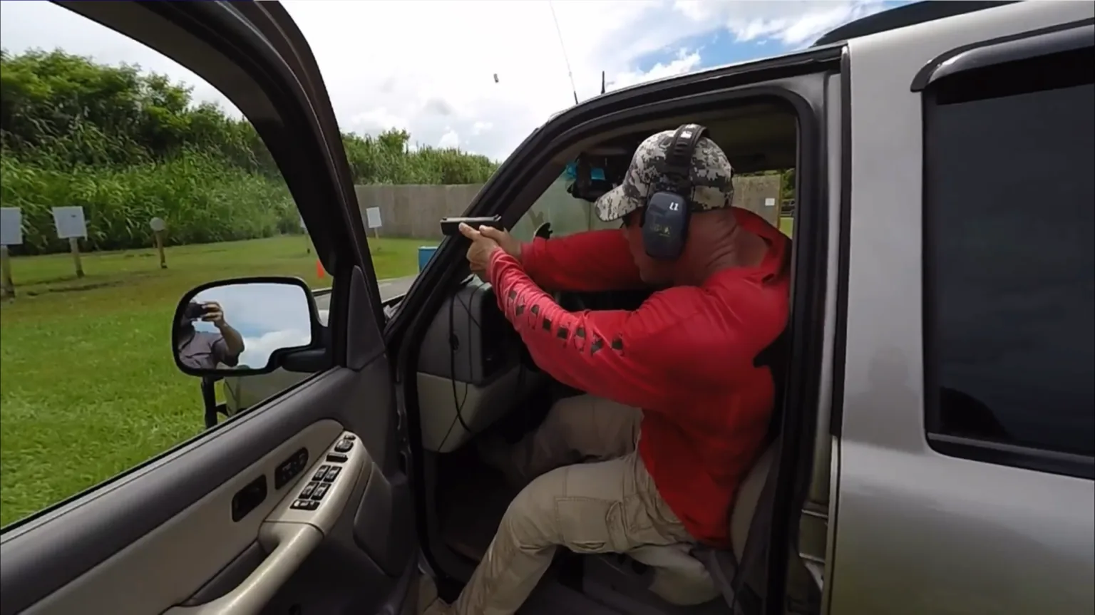 Tactical U student working pistol and rifle around a vehicle during Vehicle Tactics Level Two
