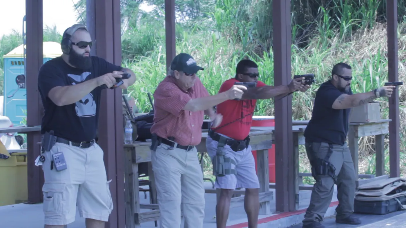 Tactical U students practicing handgun skills on a covered outdoor range in South Florida.