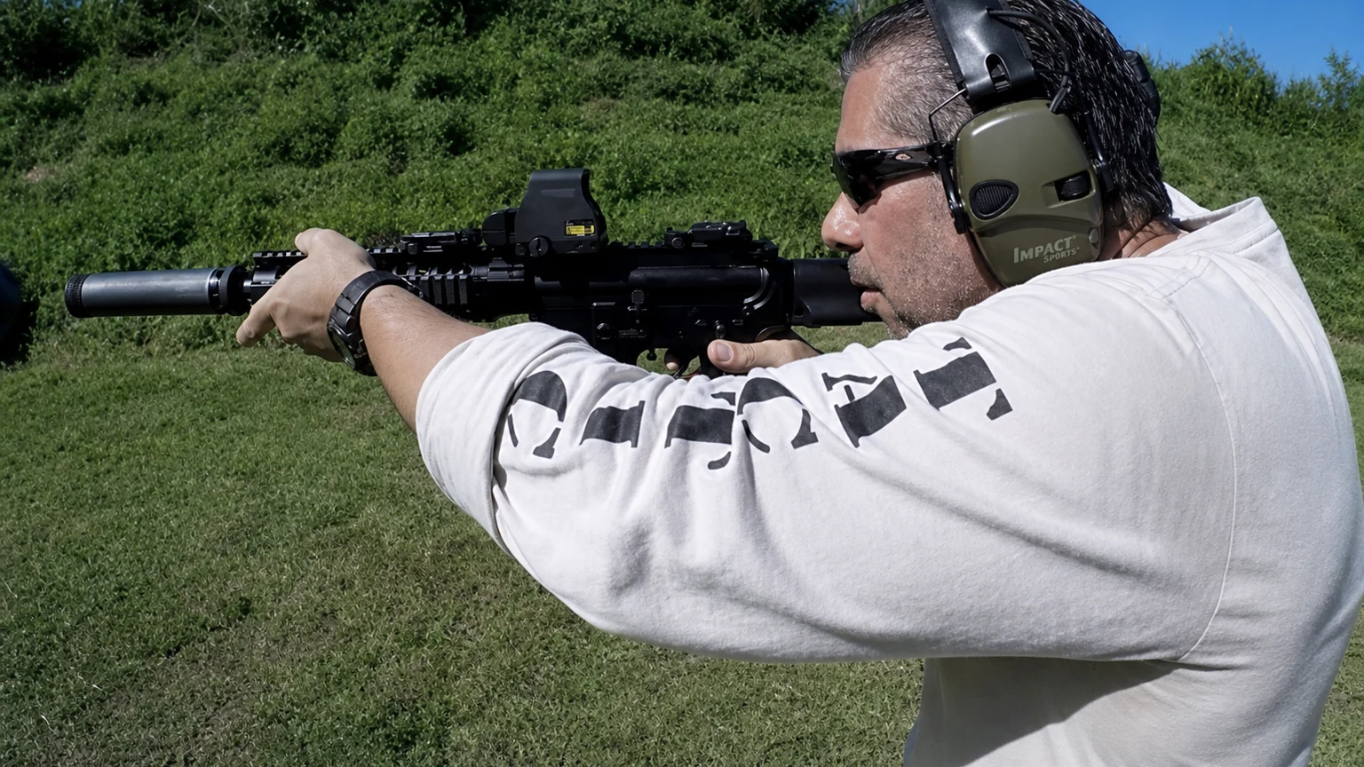 Mel Becena demonstrating suppressed rifle technique during Tactical U range training
