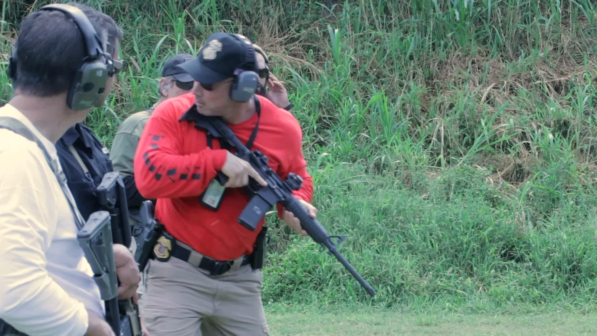 Stephen L. Cohen carrying a rifle while leading tactical range training
