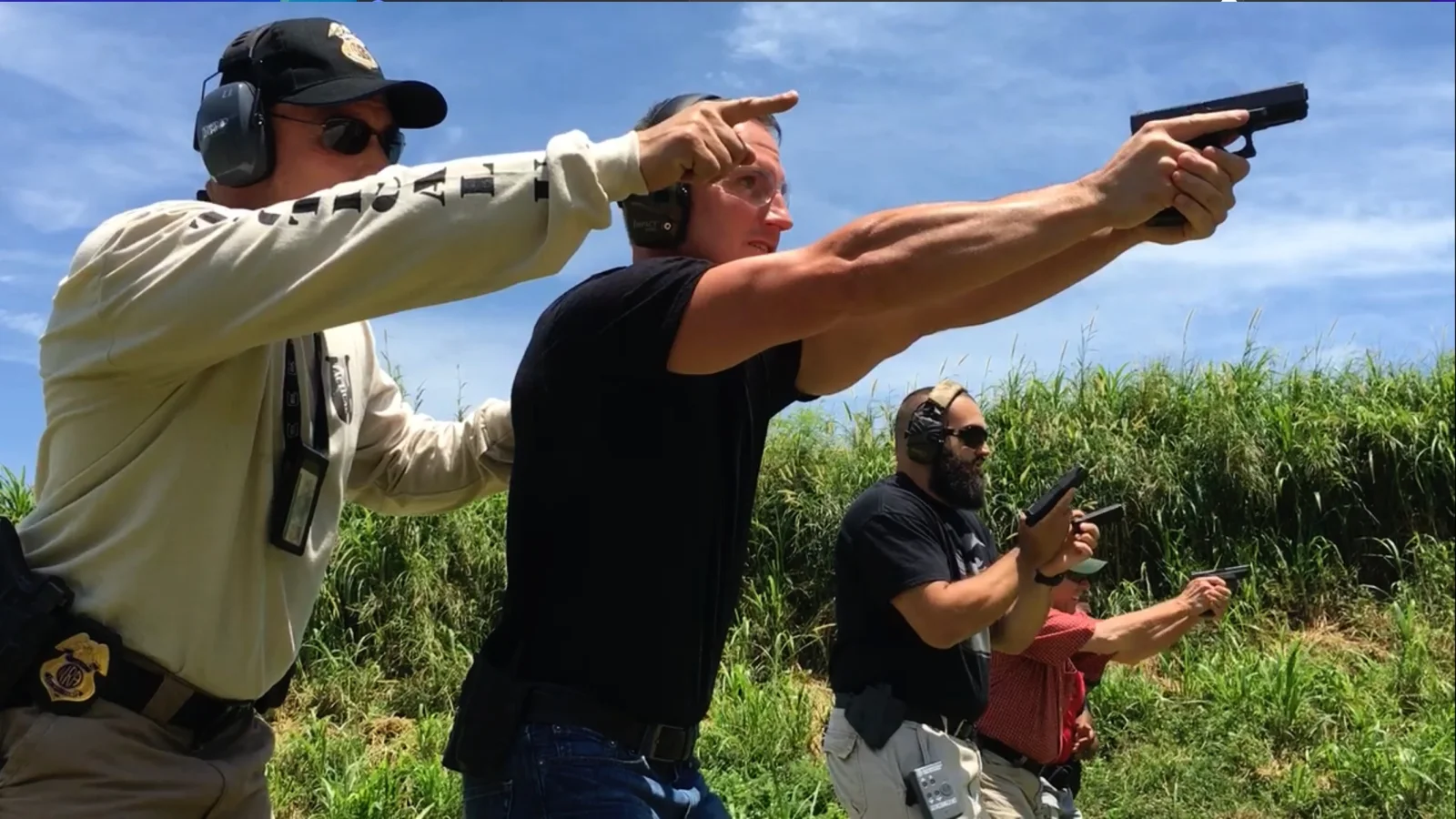 Tactical U instructor guiding a concealed carry student during live-fire handgun training