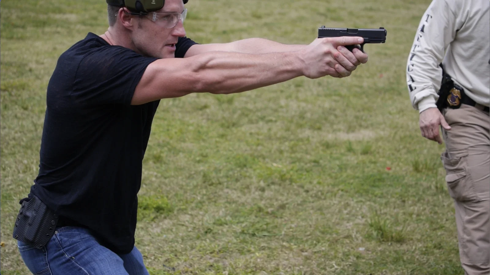 Tactical U instructor supervising a student during practical handgun tactics training
