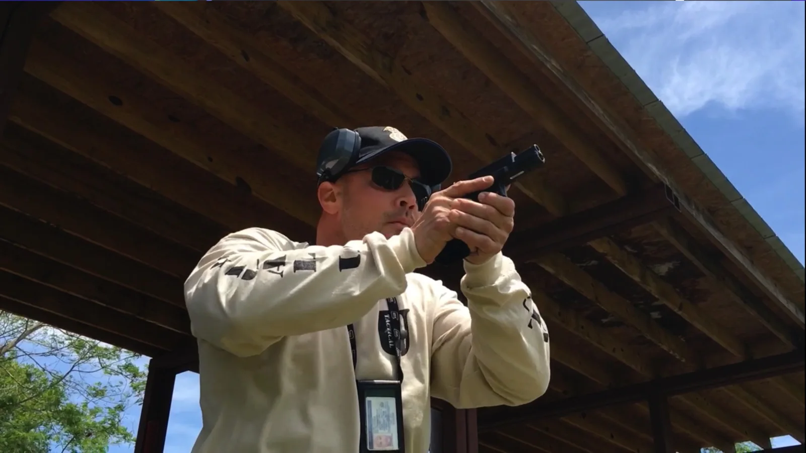 Tactical U instructor demonstrating safe handgun fundamentals on an outdoor range