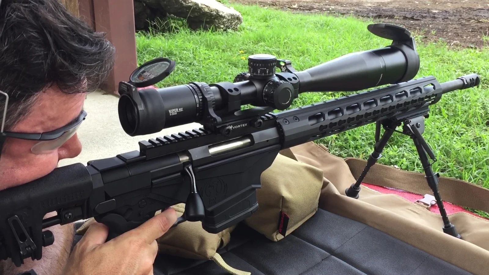 Tactical U student practicing scoped rifle marksmanship fundamentals from a supported position