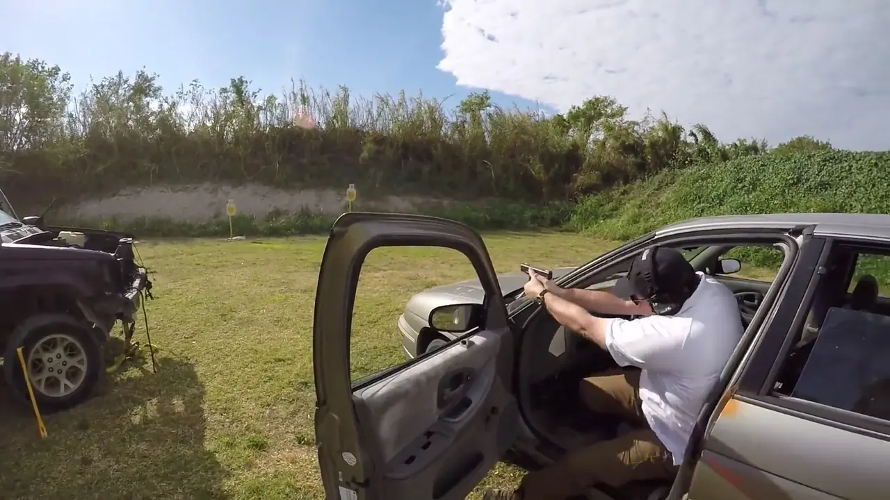 Tactical U student firing a handgun from a vehicle during South Florida vehicle tactics training