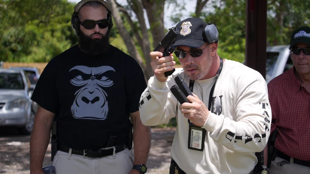 Stephen L. Cohen demonstrating a handgun reload in a Tactical U shirt