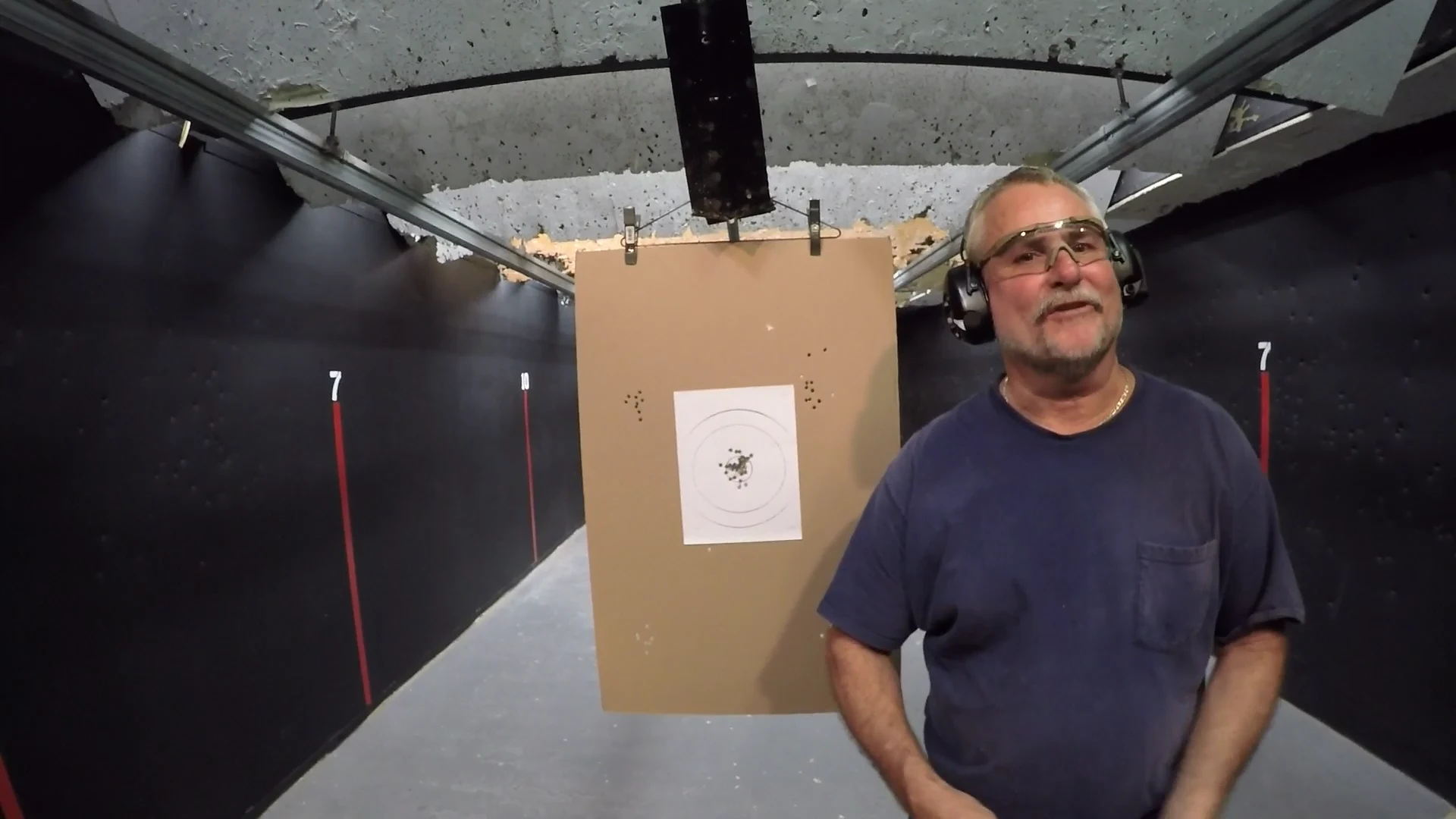 Tactical U student beside his target with a tight shot group after live-fire concealed carry training in Fort Lauderdale