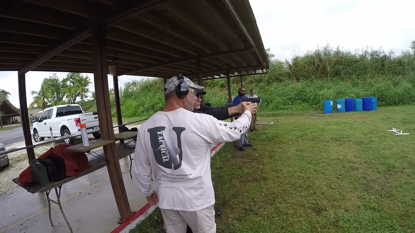 Tactical U instructor coaching a student at the covered firing line during a 2-hour Florida CWL certification class