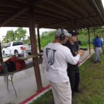 Tactical U instructor giving a student individual feedback during handgun training