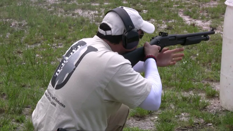 Student in a Tactical U shirt firing a pump shotgun