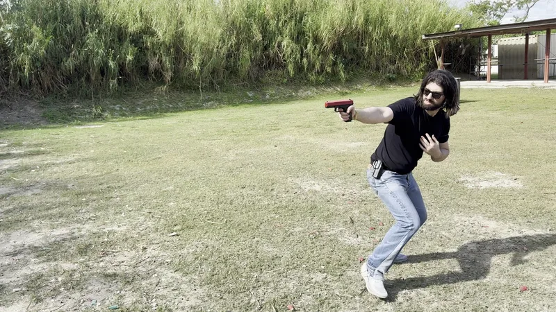 Student moving and firing a pistol at close range