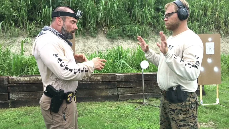 Tactical U instructor demonstrating to a student at the targets
