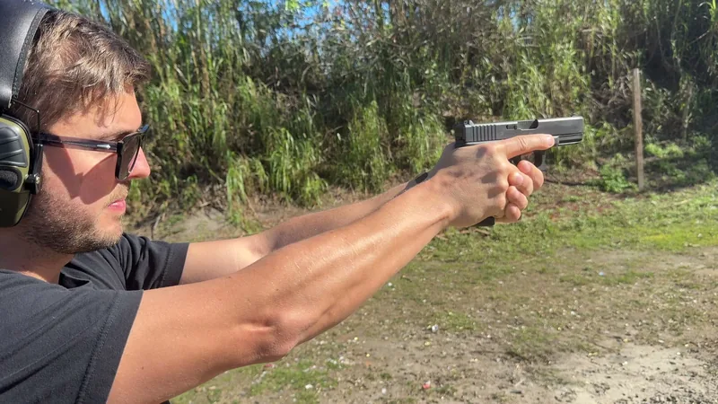 Close view of a student aiming a pistol during private handgun training