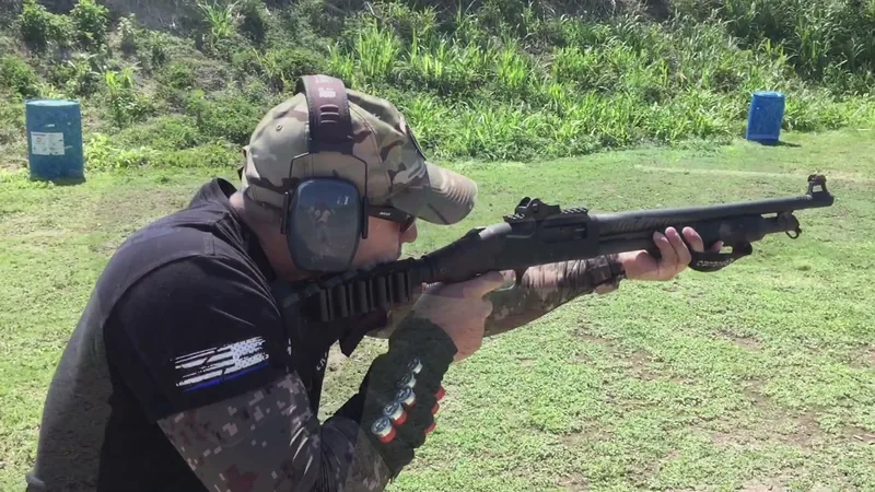 Student firing a shotgun on an outdoor range