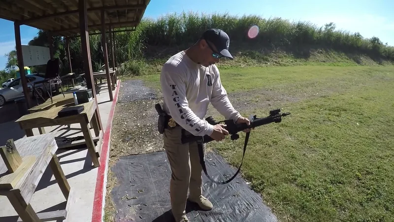 Student working an AR-style rifle on the range