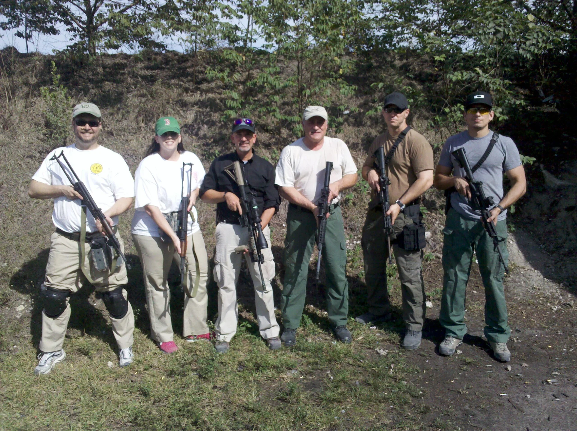 Six Tactical U rifle students standing with their rifles on an outdoor range